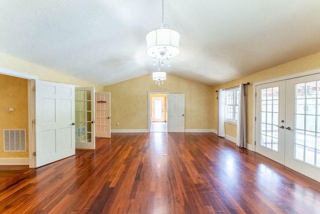 interior space with dark wood-type flooring, french doors, vaulted ceiling, and a chandelier