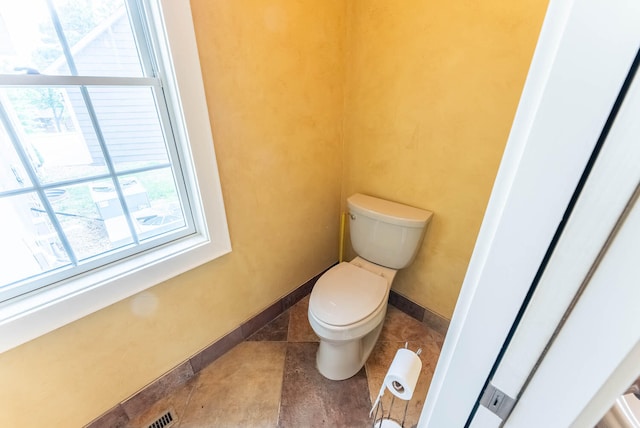 bathroom with tile patterned flooring and toilet