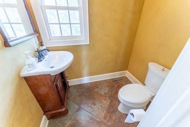 bathroom featuring toilet and vanity