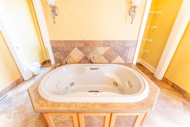 bathroom with a relaxing tiled tub