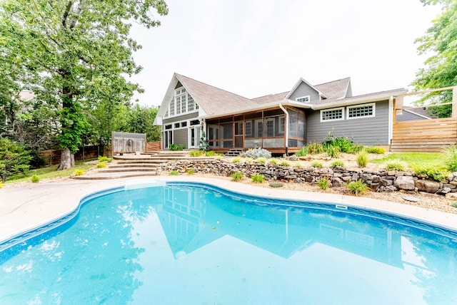 view of swimming pool with a sunroom