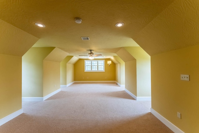 bonus room featuring lofted ceiling, ceiling fan, and light carpet