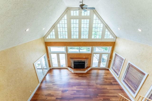 unfurnished living room featuring a healthy amount of sunlight, french doors, and dark hardwood / wood-style flooring