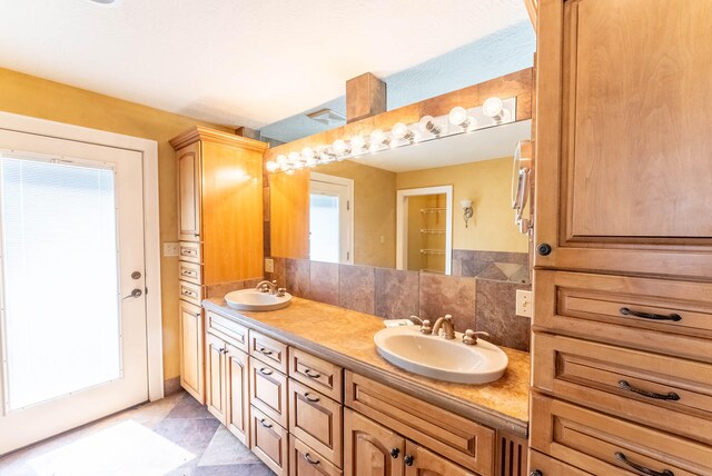 bathroom featuring decorative backsplash and vanity