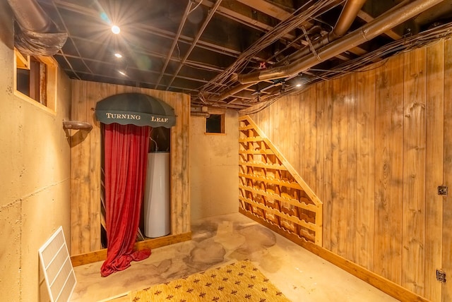 basement featuring wood walls