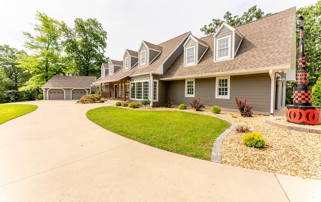 cape cod house featuring a garage and a front yard