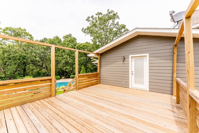 deck featuring a swimming pool