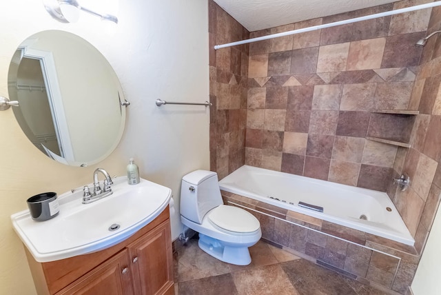 full bathroom featuring toilet, tile patterned floors, tiled shower / bath, vanity, and a textured ceiling