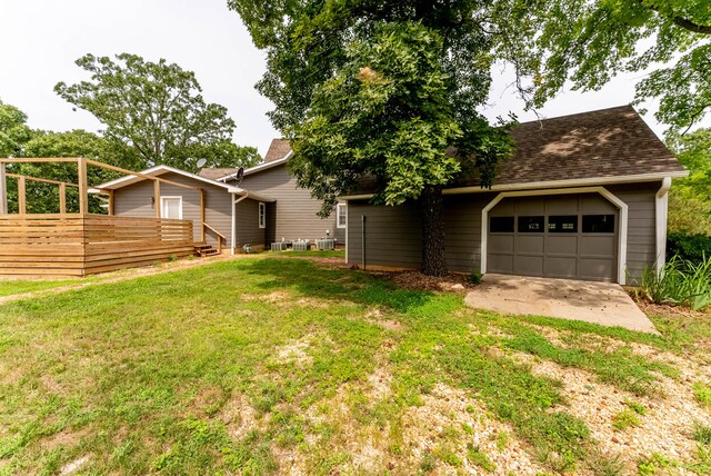 exterior space featuring a wooden deck and a garage