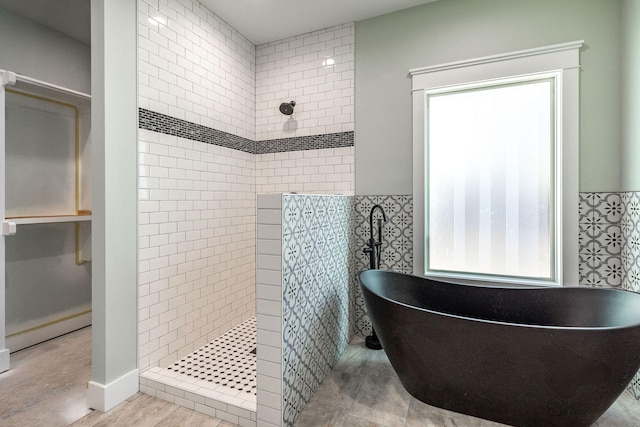 bathroom with shower with separate bathtub