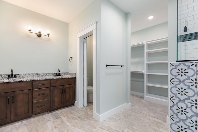 bathroom with toilet and vanity