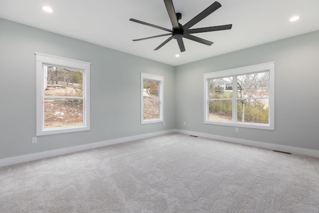 empty room featuring ceiling fan and carpet flooring