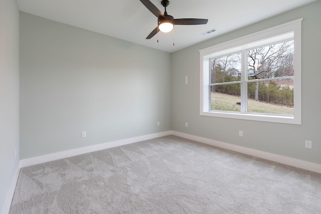 unfurnished room with ceiling fan and light colored carpet