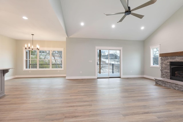 unfurnished living room featuring plenty of natural light, lofted ceiling, and a fireplace