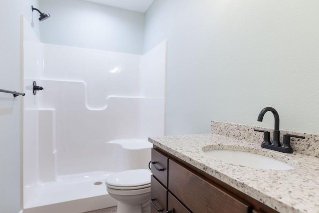 bathroom with toilet, walk in shower, and vanity