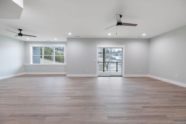 unfurnished room featuring ceiling fan, plenty of natural light, and light hardwood / wood-style floors