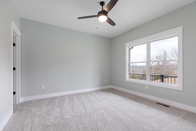 spare room with ceiling fan and carpet flooring