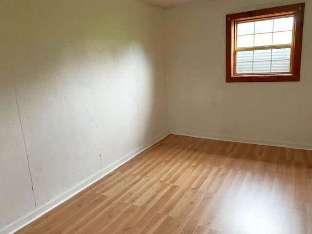 unfurnished room with light hardwood / wood-style flooring