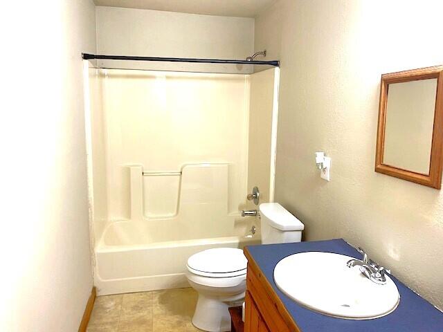 full bathroom with tile patterned flooring, toilet, shower / bathtub combination, and vanity