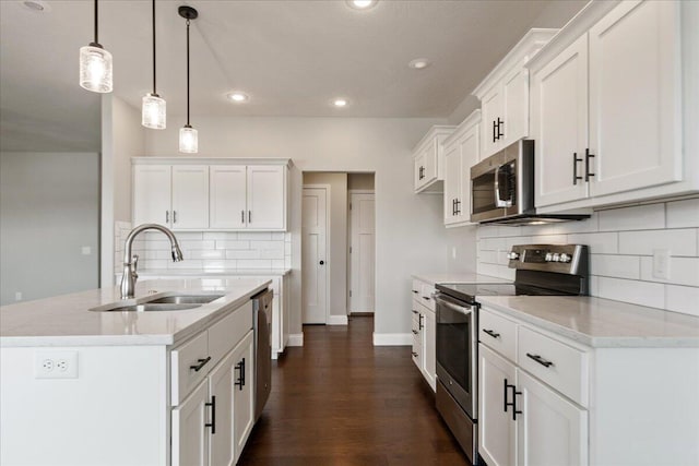 kitchen with white cabinetry, decorative light fixtures, sink, and stainless steel appliances