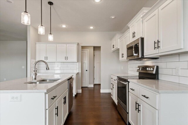 1641 N Pinnacle Ave, Nixa, MO 65714 - kitchen featuring white cabinets, a sink, backsplash, dark wood-type flooring, and appliances with stainless steel finishes