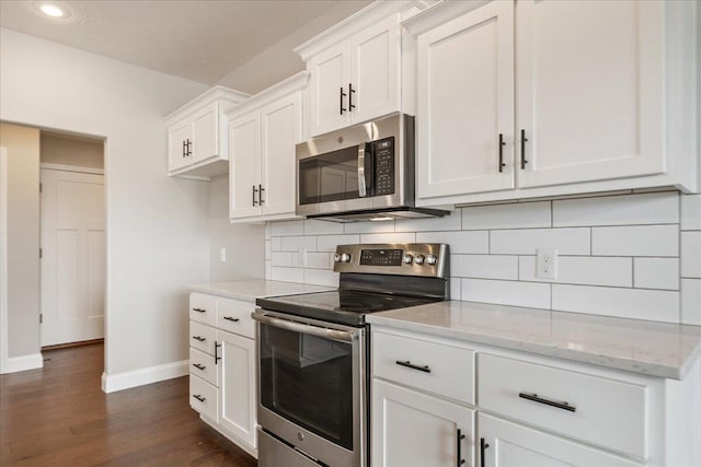 1641 N Pinnacle Ave, Nixa, MO 65714 - kitchen featuring baseboards, dark wood-style flooring, stainless steel appliances, and white cabinetry