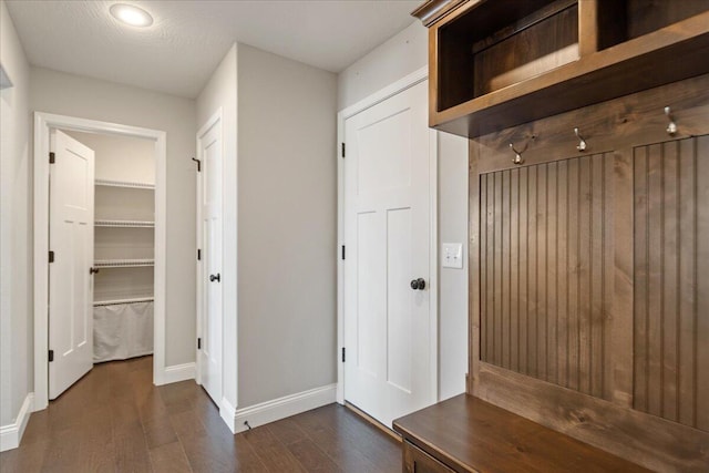 mudroom with a textured ceiling and dark hardwood / wood-style flooring