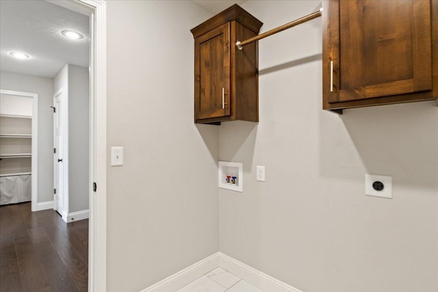 laundry area with washer hookup, hookup for an electric dryer, cabinets, and wood-type flooring