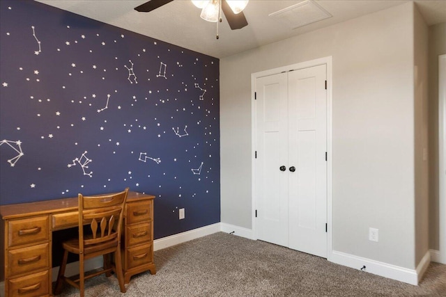 unfurnished office featuring a textured ceiling, ceiling fan, and carpet flooring