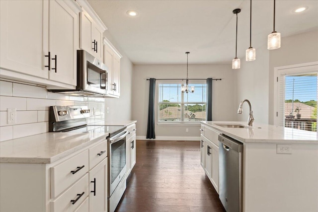 kitchen with dark hardwood / wood-style floors, stainless steel appliances, sink, white cabinetry, and decorative light fixtures