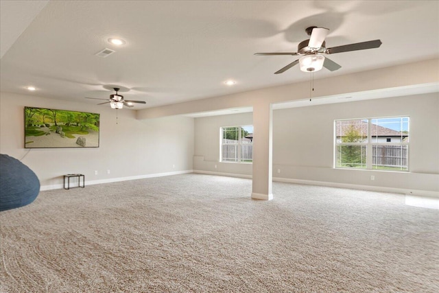 unfurnished living room featuring carpet floors, ceiling fan, and a healthy amount of sunlight