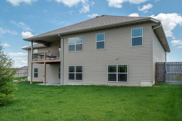 1641 N Pinnacle Ave, Nixa, MO 65714 - back of house featuring a lawn, fence, and a balcony