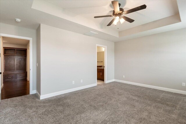 1641 N Pinnacle Ave, Nixa, MO 65714 - unfurnished bedroom featuring a tray ceiling, carpet floors, baseboards, and ensuite bathroom