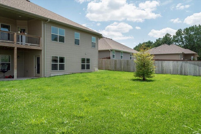 1641 N Pinnacle Ave, Nixa, MO 65714 - back of house with fence, a lawn, and a balcony