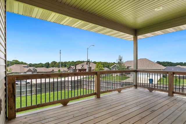 wooden deck featuring a yard