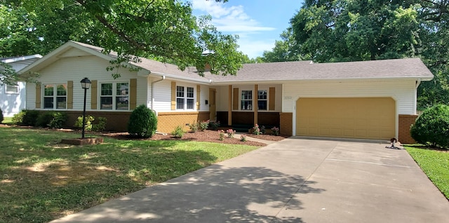 ranch-style house featuring a front yard and a garage