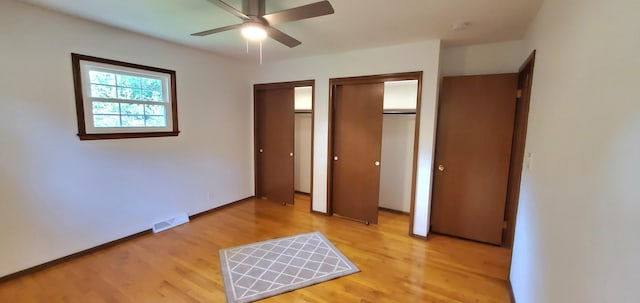 unfurnished bedroom with ceiling fan and wood-type flooring