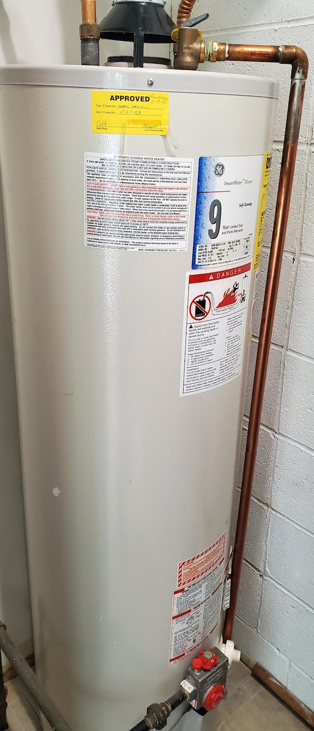 utility room with gas water heater