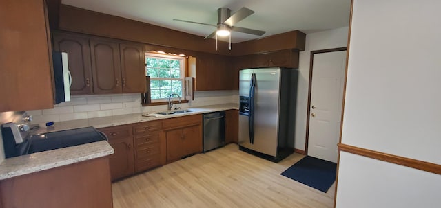 kitchen with sink, range with electric cooktop, stainless steel fridge with ice dispenser, dishwasher, and light hardwood / wood-style floors