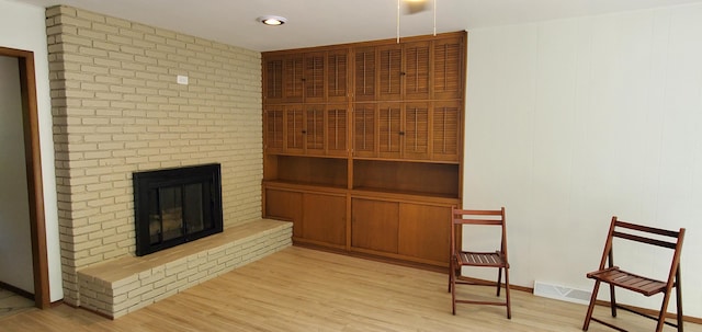 living room with a fireplace and light hardwood / wood-style floors