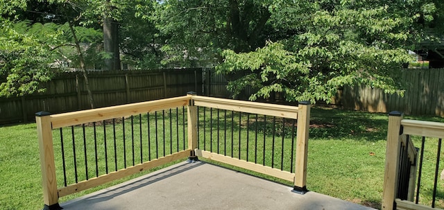 wooden terrace featuring a yard