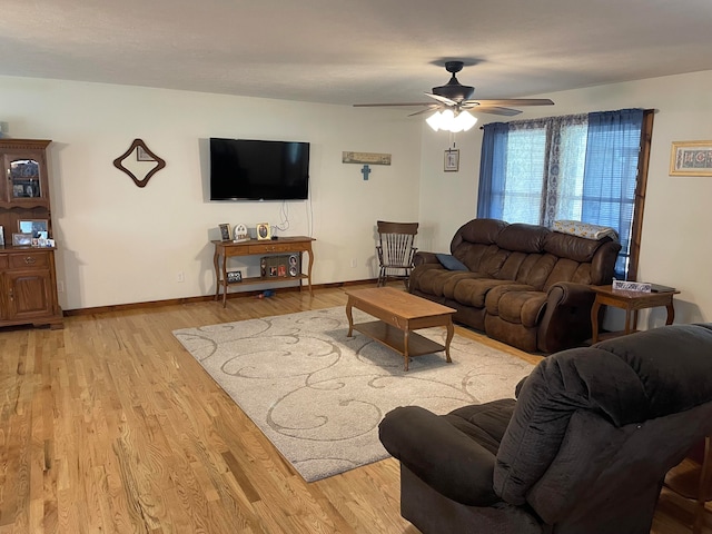 living room featuring light wood-type flooring and ceiling fan