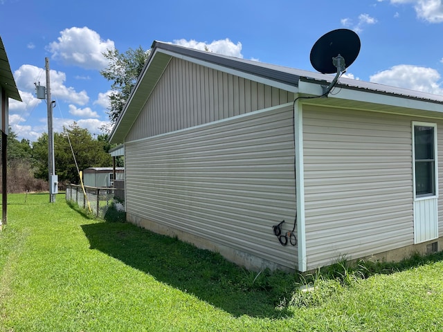 view of side of property with a lawn