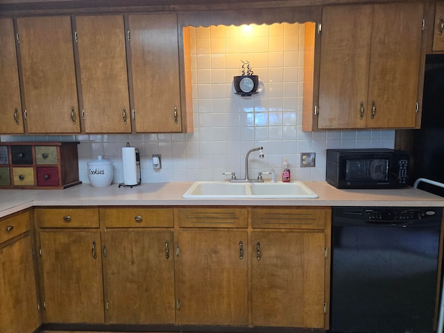 kitchen with backsplash, black appliances, and sink