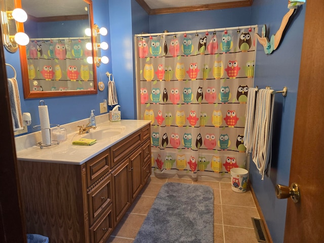 bathroom with crown molding, tile patterned floors, a shower with shower curtain, and vanity