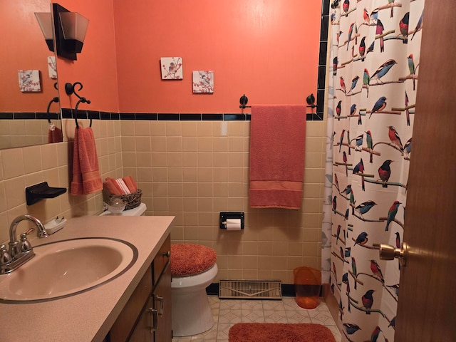 bathroom featuring vanity, tile patterned floors, tile walls, toilet, and a shower with shower curtain