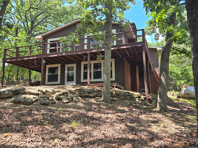 rear view of house with a wooden deck