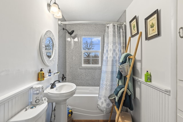 bathroom with shower / bathtub combination with curtain and toilet