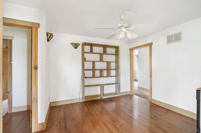 empty room featuring wood-type flooring and ceiling fan