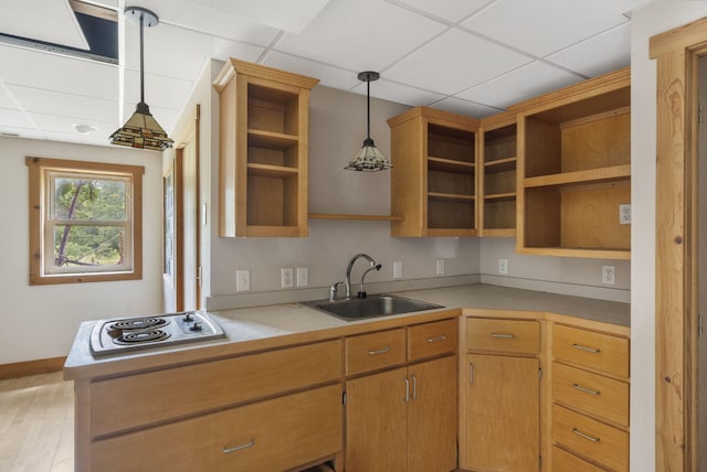 kitchen with light wood-type flooring, a drop ceiling, sink, pendant lighting, and white gas cooktop